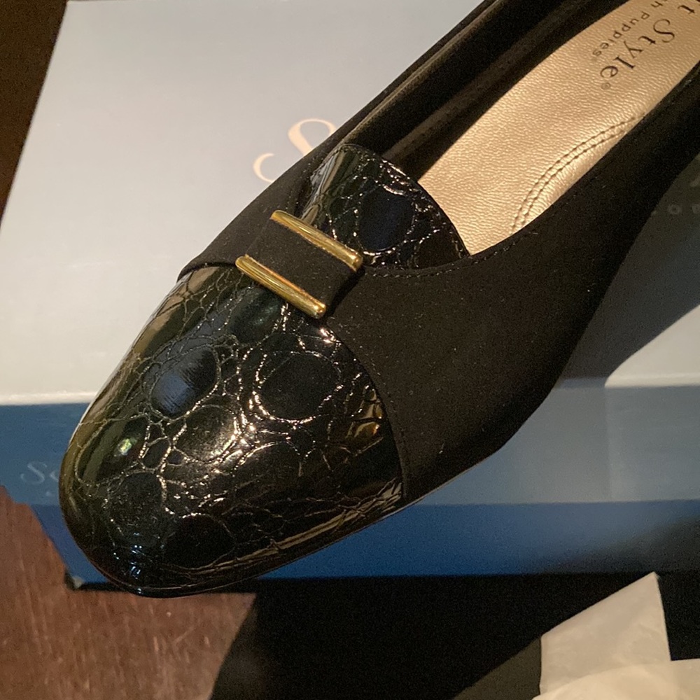 Suede and patent leather on a low-heeled shoe.